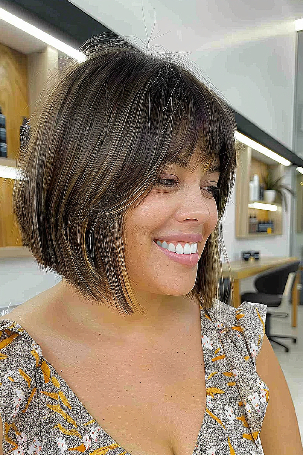 Woman with a multi-tonal brown A-line bob and feathered bangs