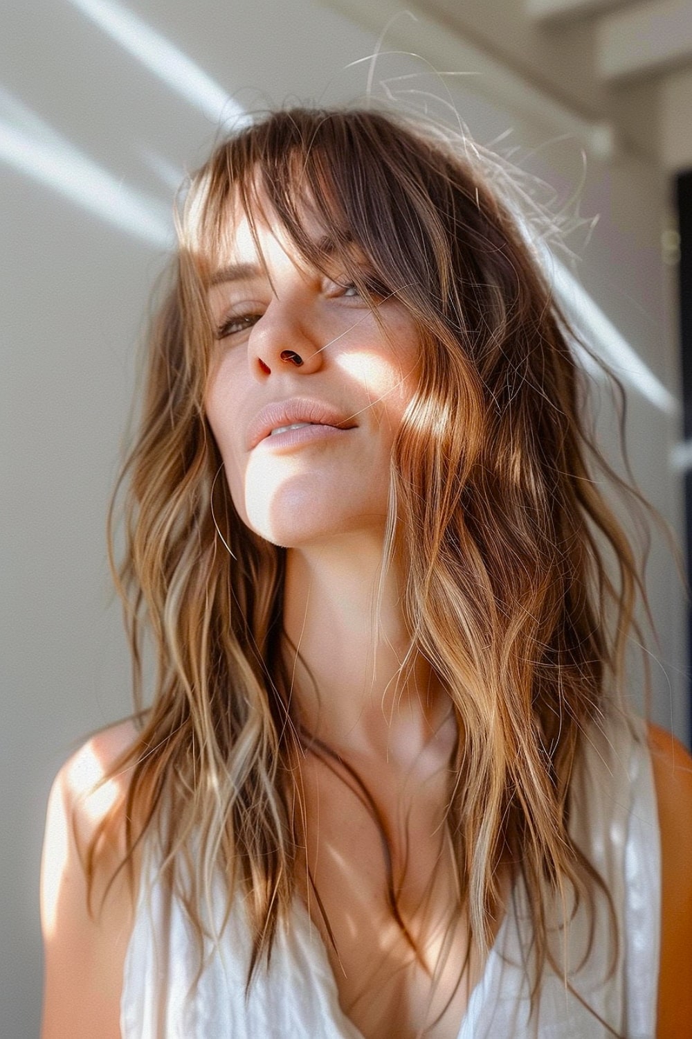 Woman with a boho shag haircut and wispy bangs