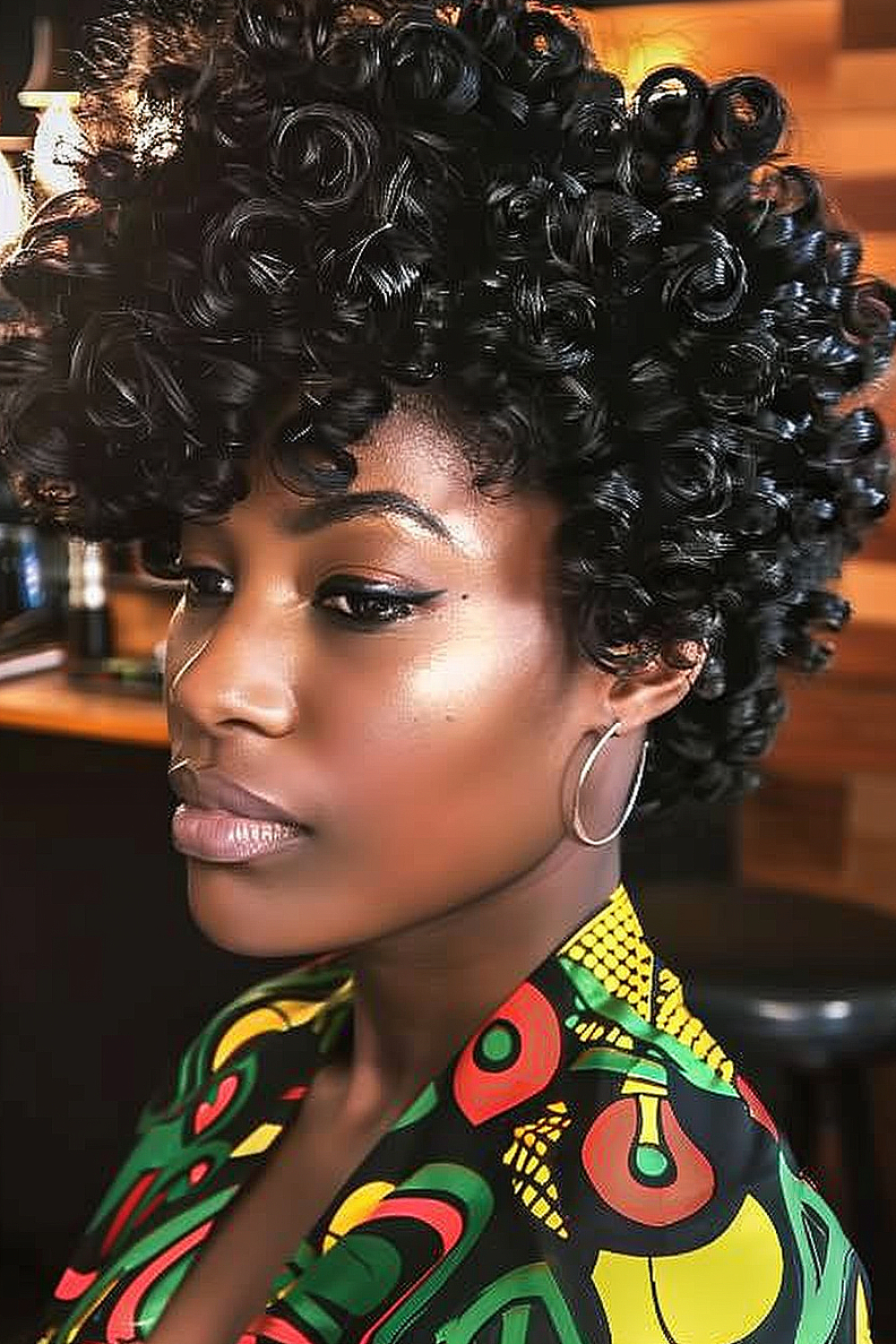 Woman with bouncy curly afro and side-swept bangs