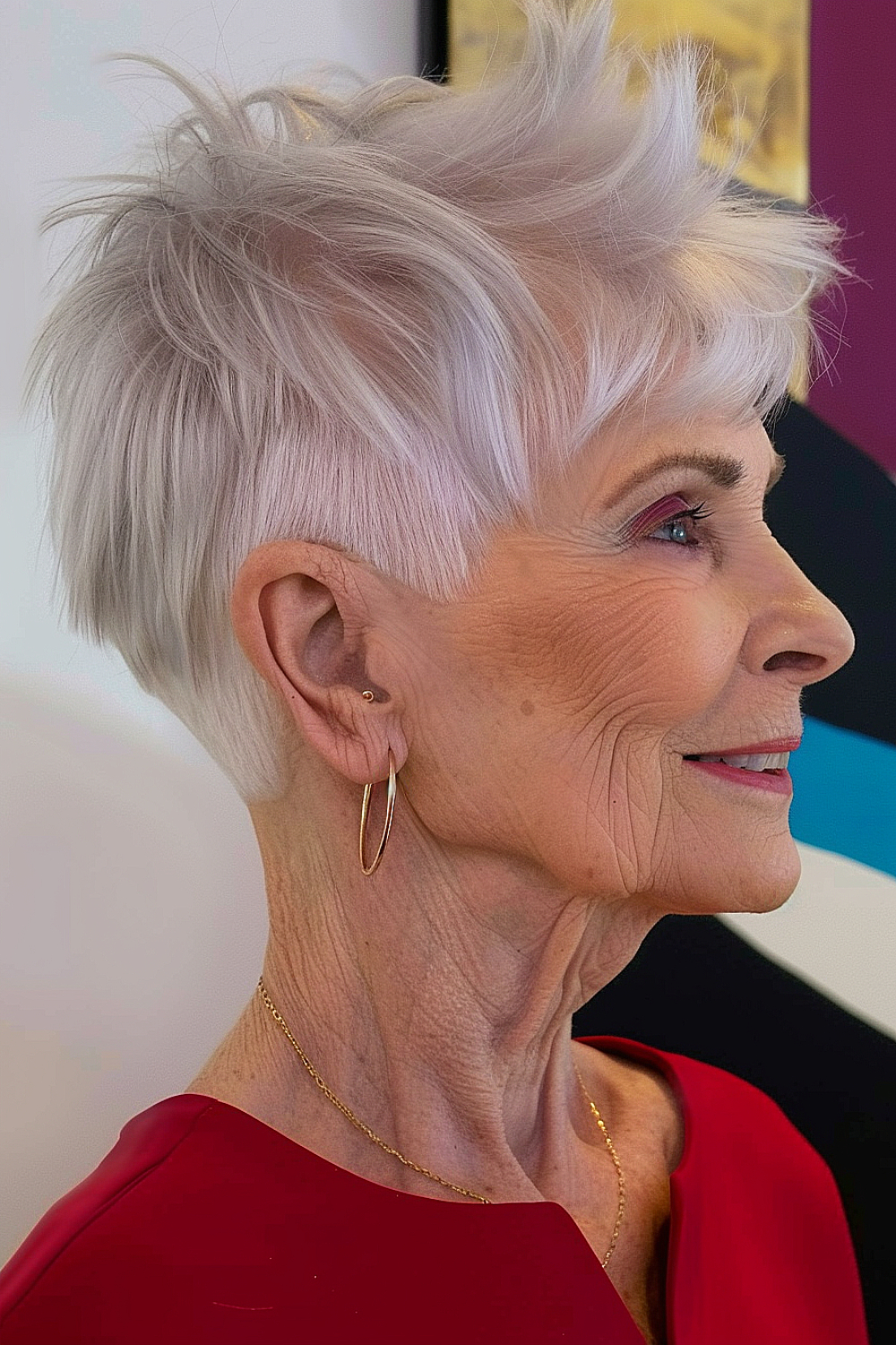 Woman with a chic silver cropped hairstyle with textured layers for women over 70