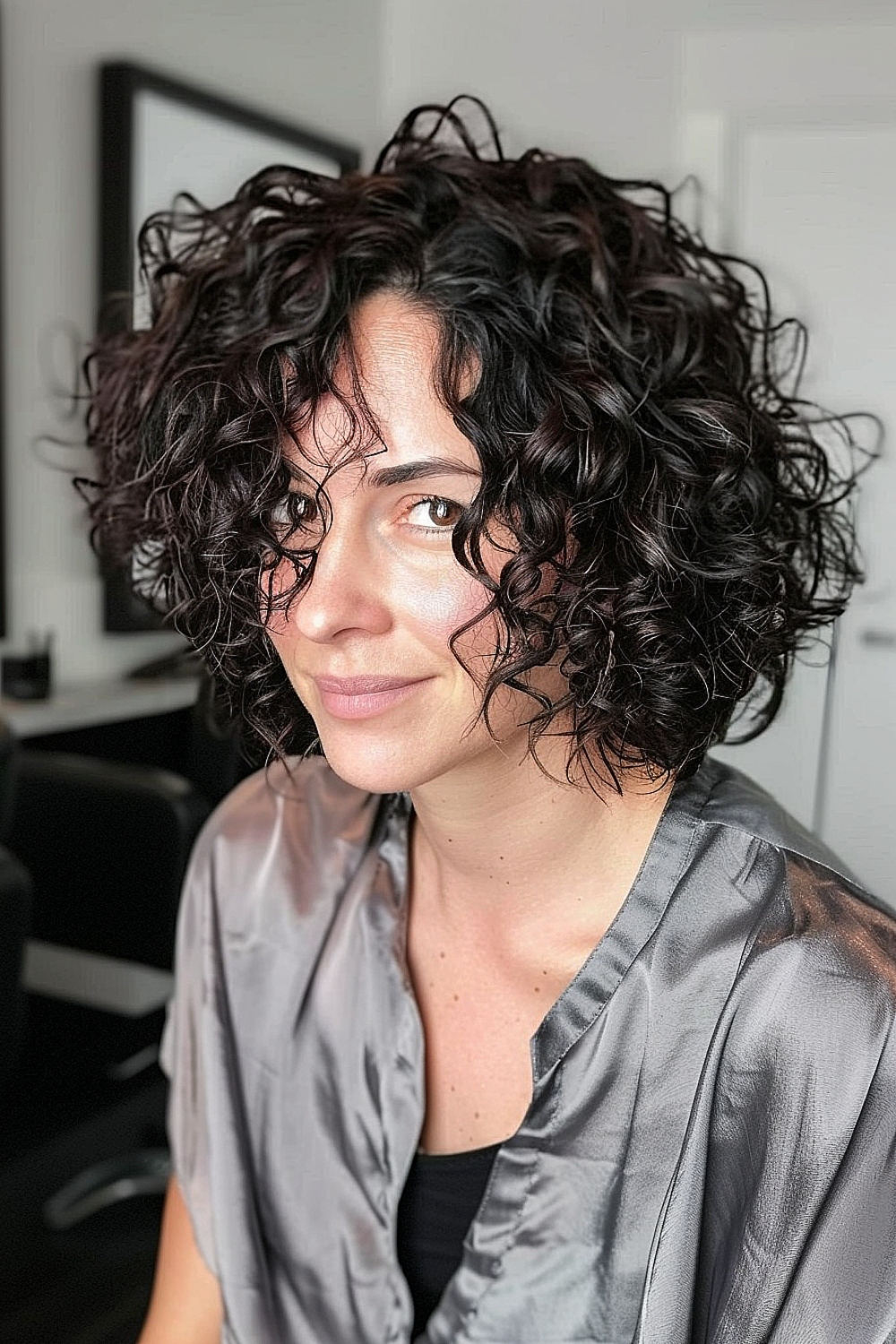 Chin-length curly bob with tousled, voluminous curls