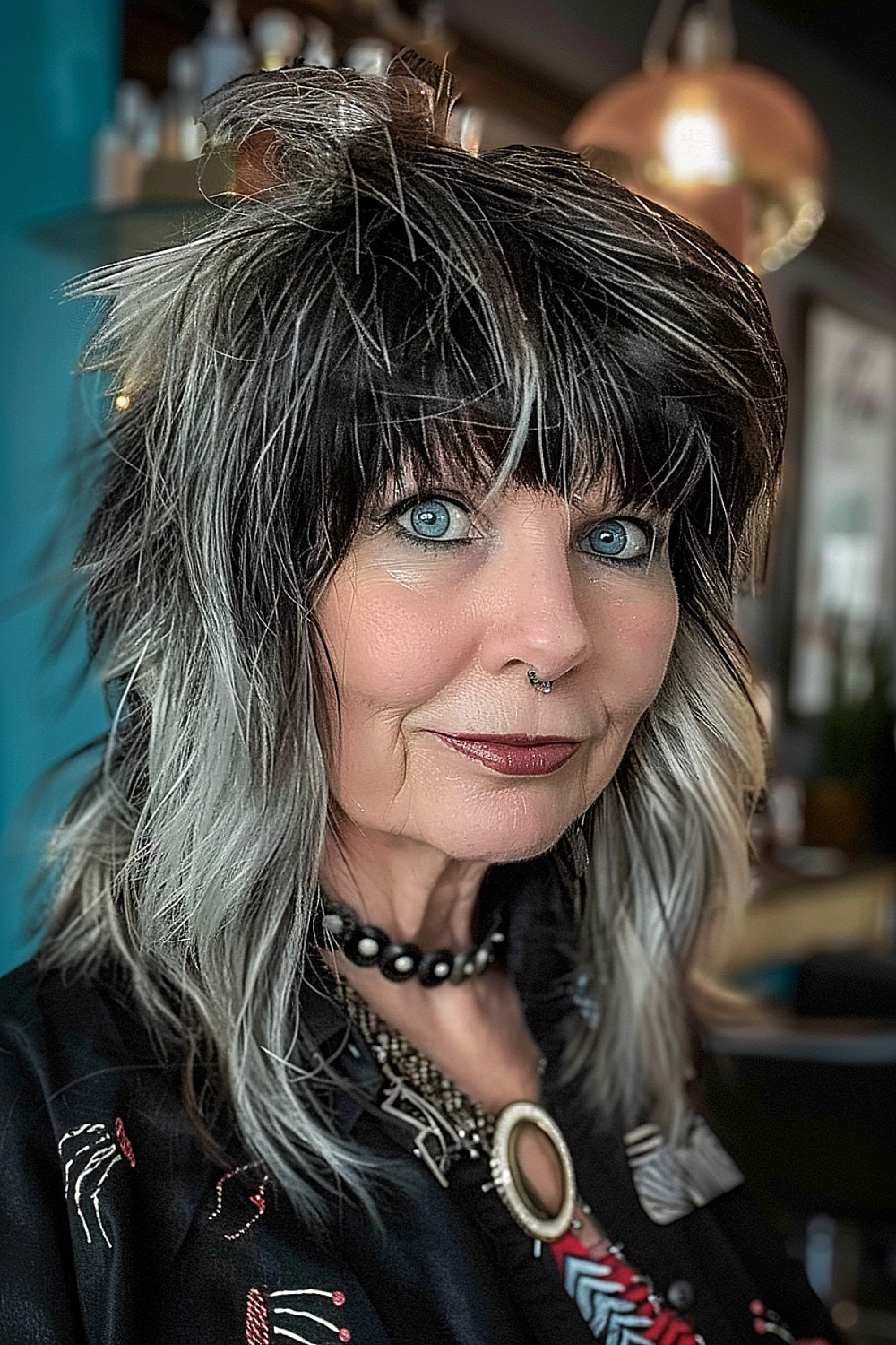 Woman with a shag haircut featuring bold platinum streaks and textured bangs