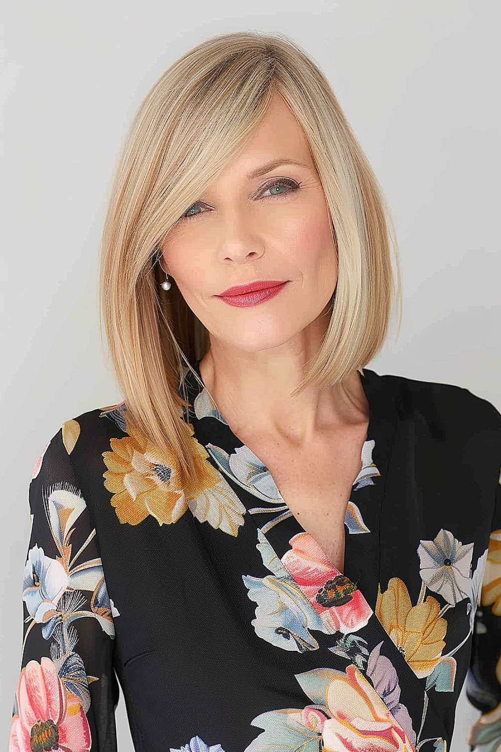 Shoulder-length honey blonde bob with a side part on a woman over 70.