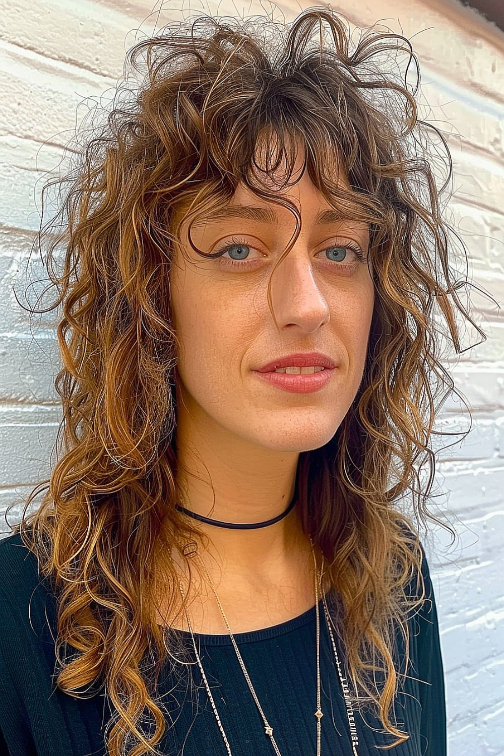 Woman with a curly shag featuring disconnected layers