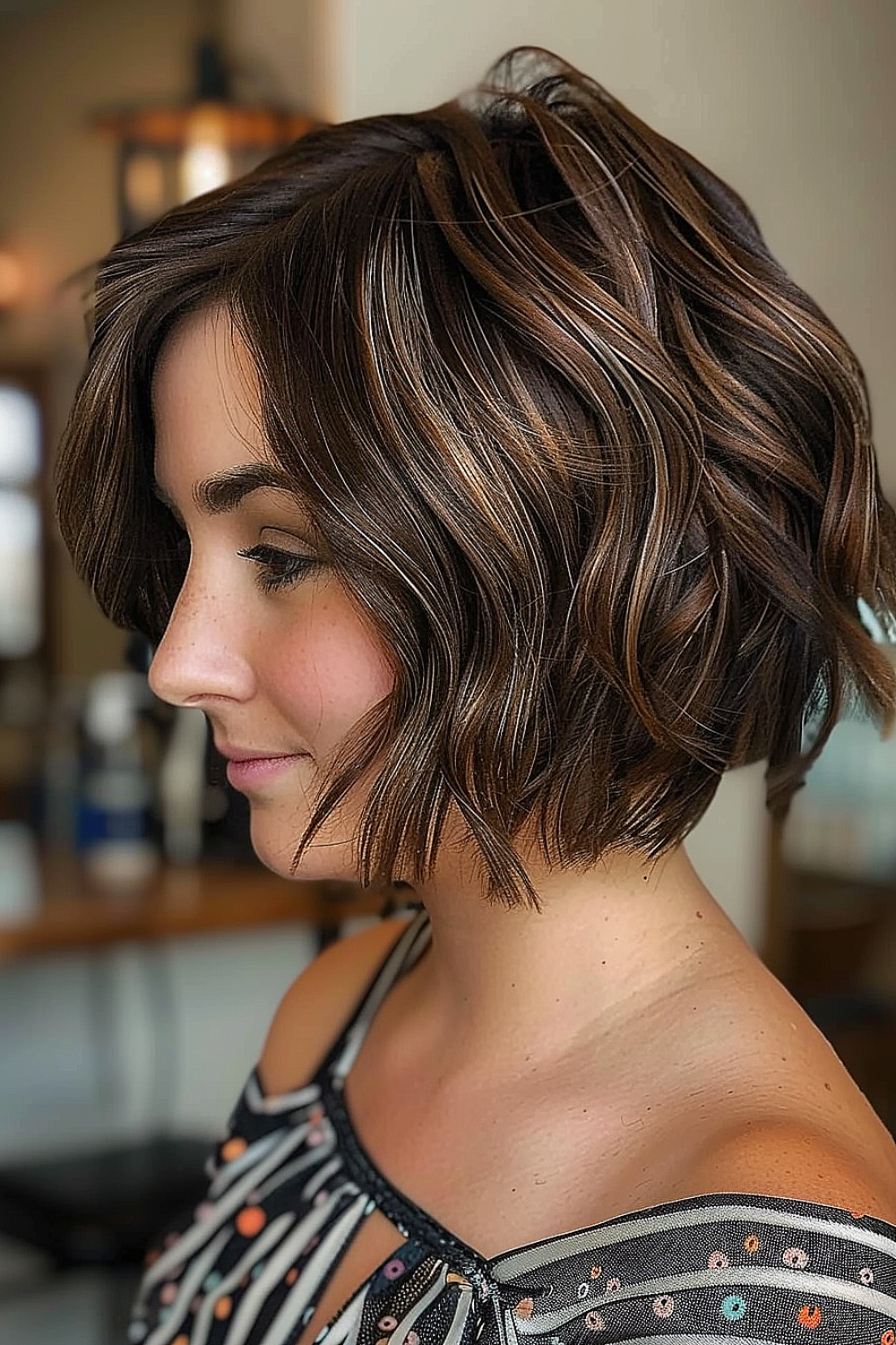 Woman with a curved textured bob and chocolate highlights