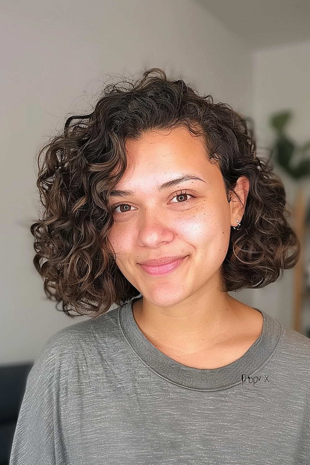 Woman with a deep side part curly lob