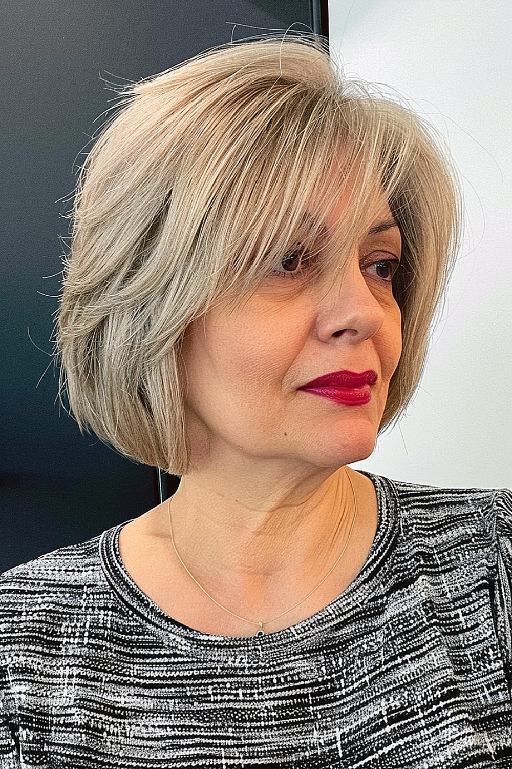 Feathered choppy bob with soft layers and side-swept bangs