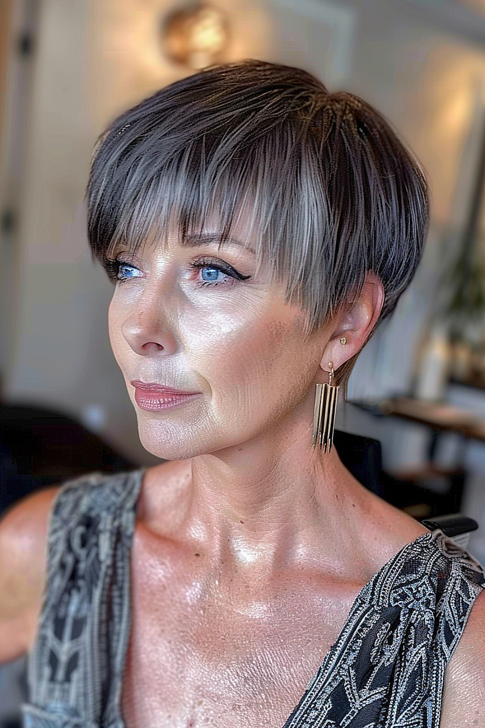 A woman with a long pixie cut and diagonal bangs