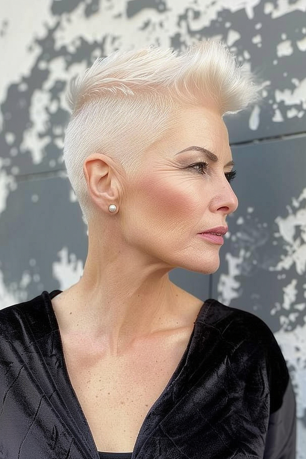 Platinum blonde pixie cut with undercut and volume on top