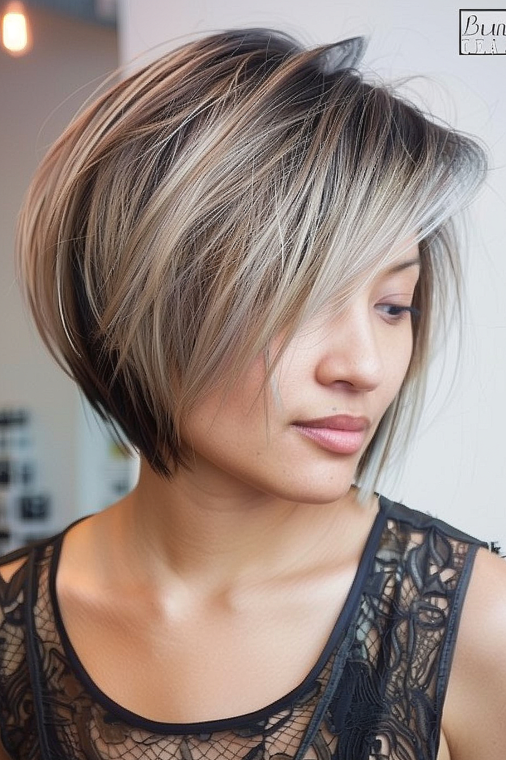 Razor cut bob with deep side part and layered texture