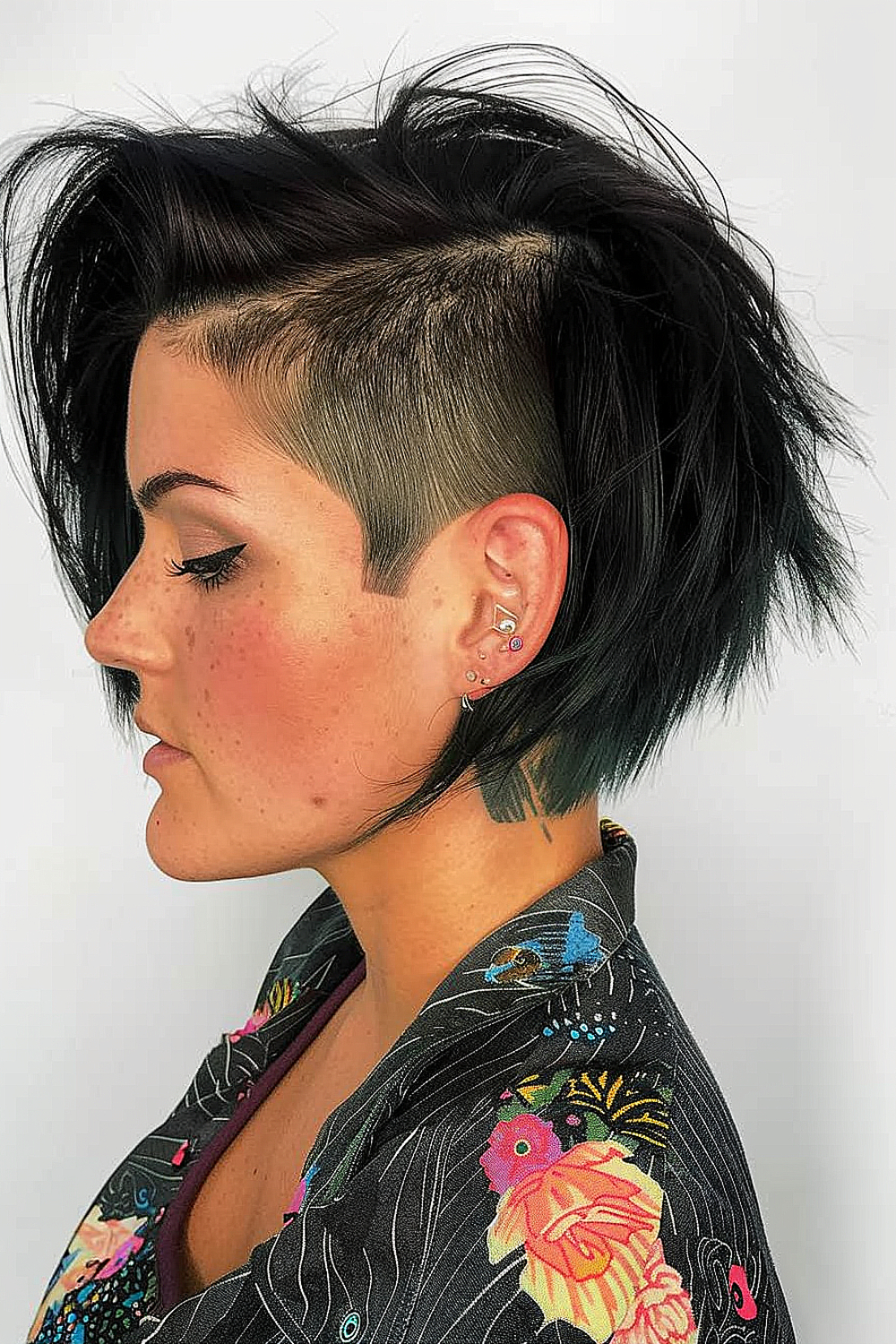 Woman with a razored shag haircut and edgy undercut