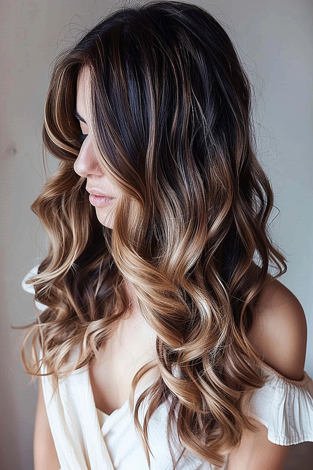 Long, romantic soft waves with a subtle ombre from dark roots to lighter ends