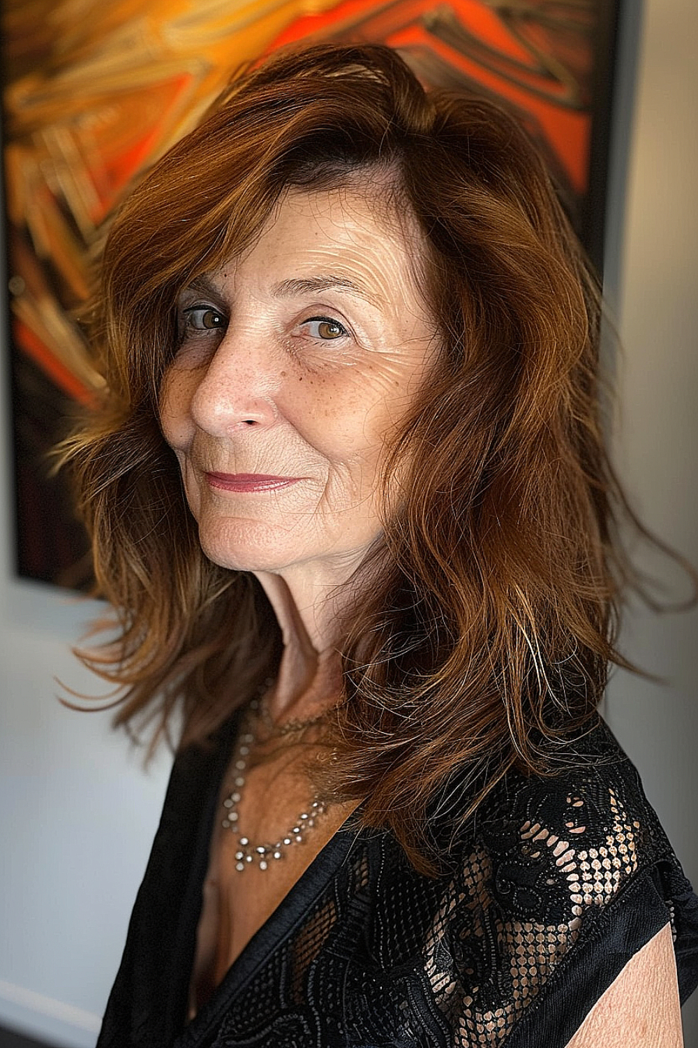 Woman with a shoulder-length shag haircut featuring a deep side part and warm brown tones with auburn highlights