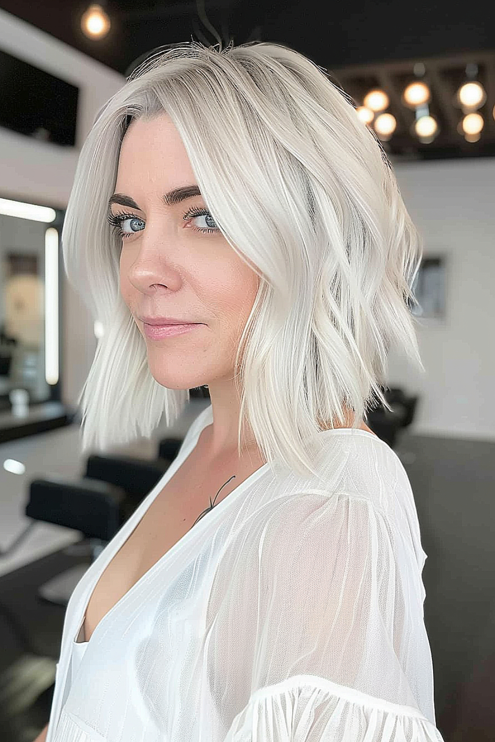 Woman with a sleek textured bob and ice blonde hair