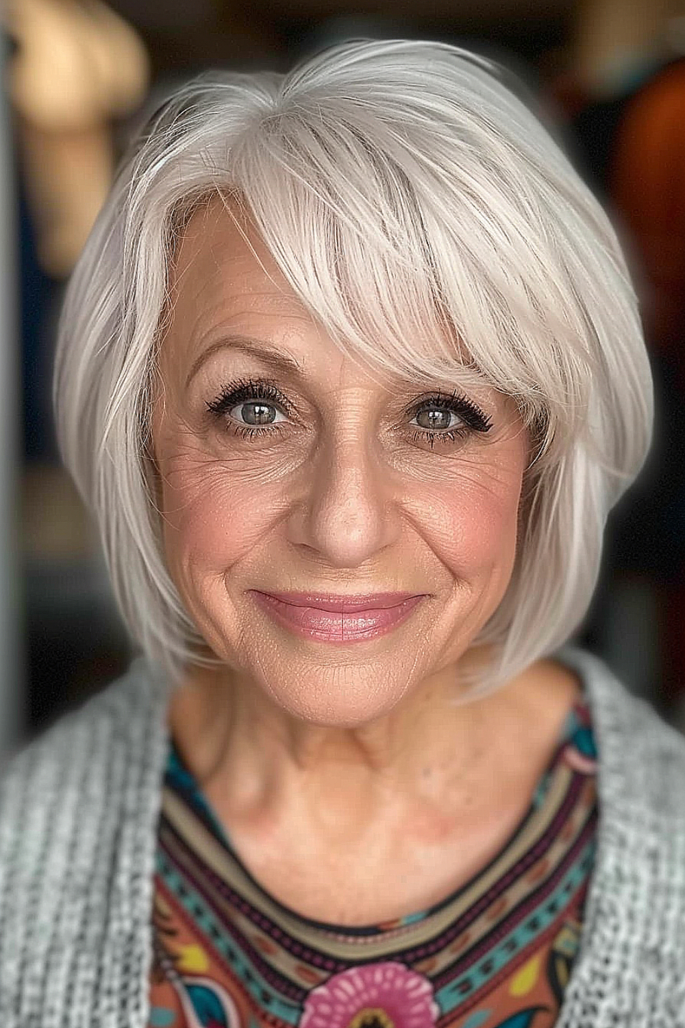 Smiling woman with a platinum soft fringe bob hairstyle