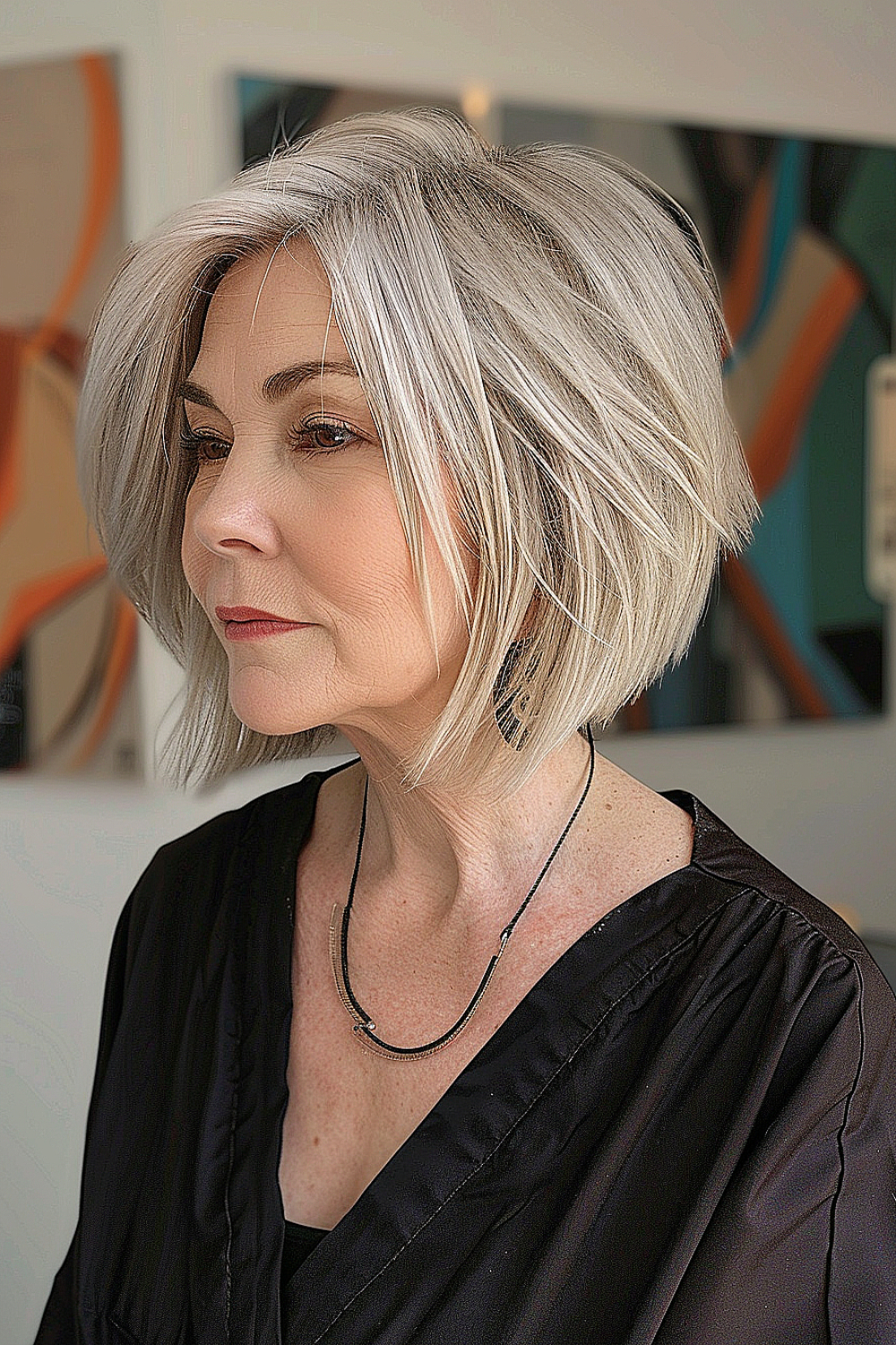 Woman with a sleek silver bob, tapered neckline, and hidden undercut