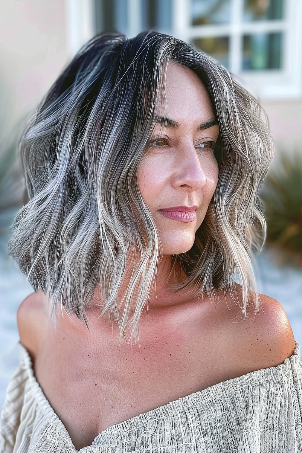 Short hair with textured beach waves and natural gray highlights