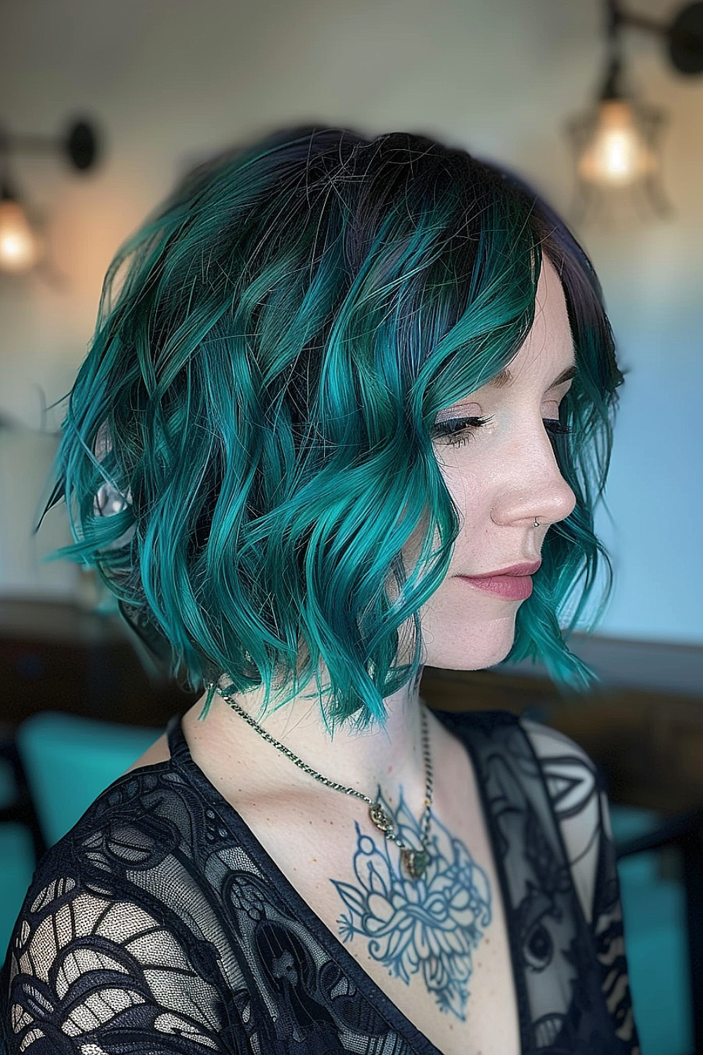 Woman with a textured bob and teal highlights.