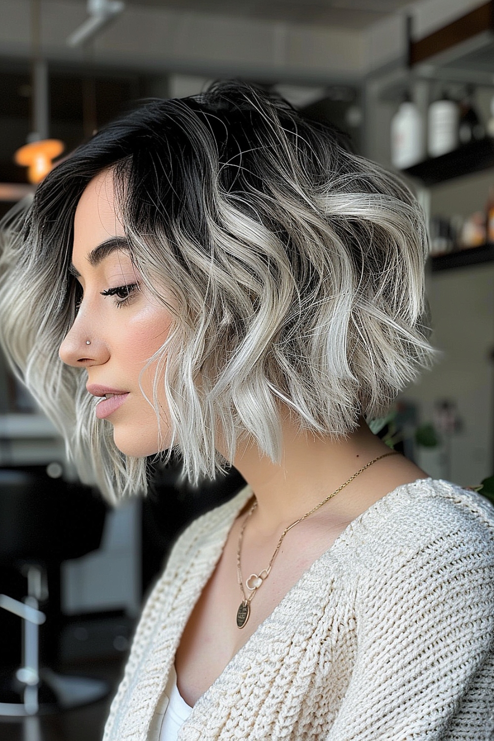 Woman with a textured wavy bob and shadow root