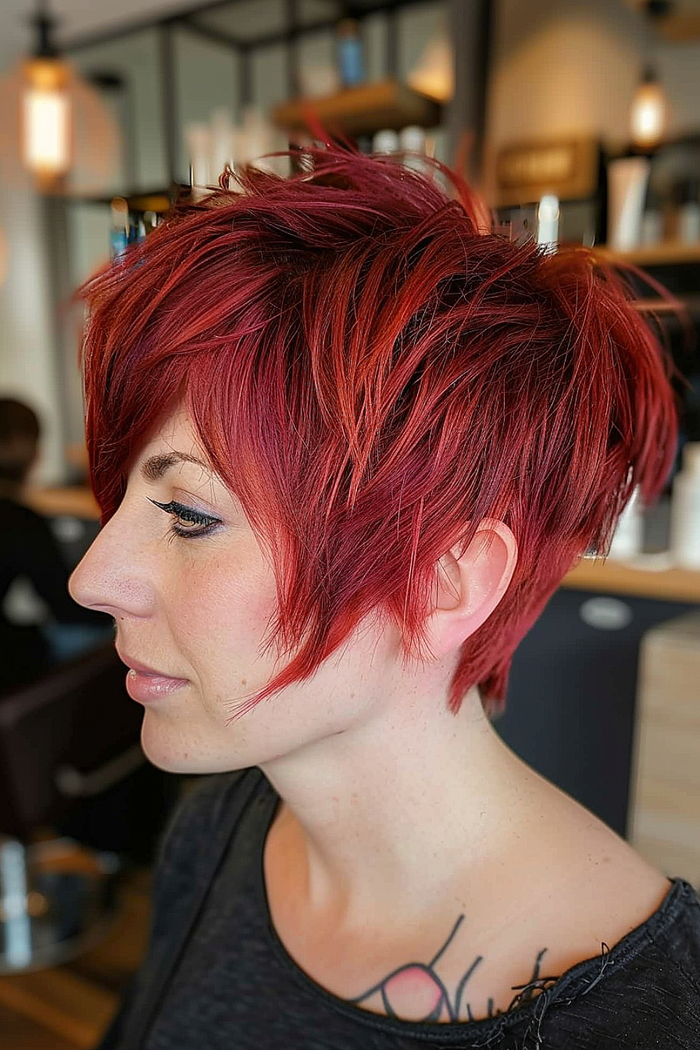 Woman with a vibrant red bixie haircut and razor-cut edges