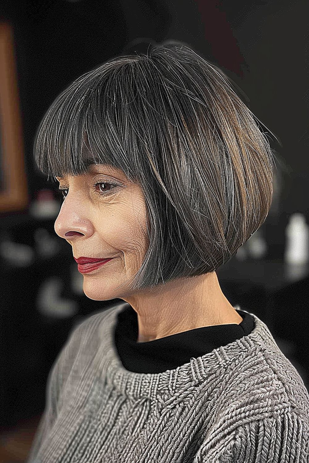 A woman with a voluminous bob haircut and arching bangs