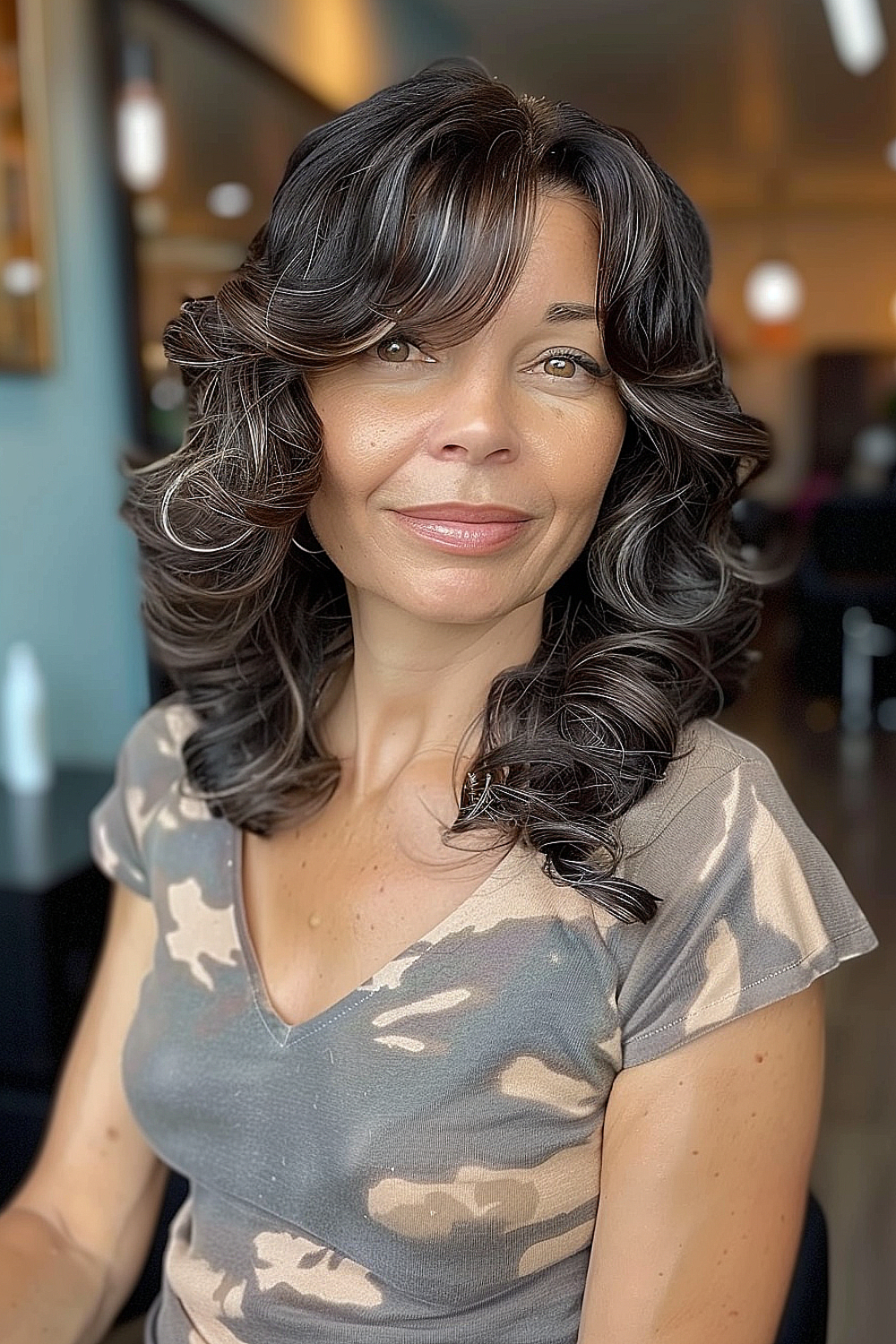 Voluminous curls with side-swept bangs