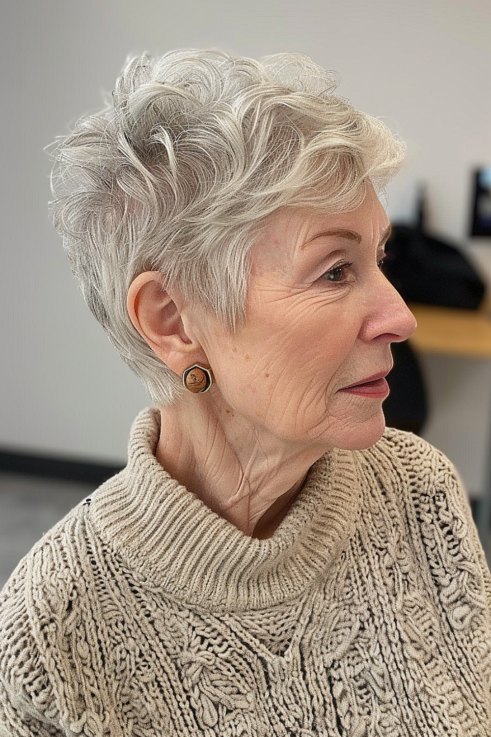 Windblown pixie cut with tousled layers in soft silver